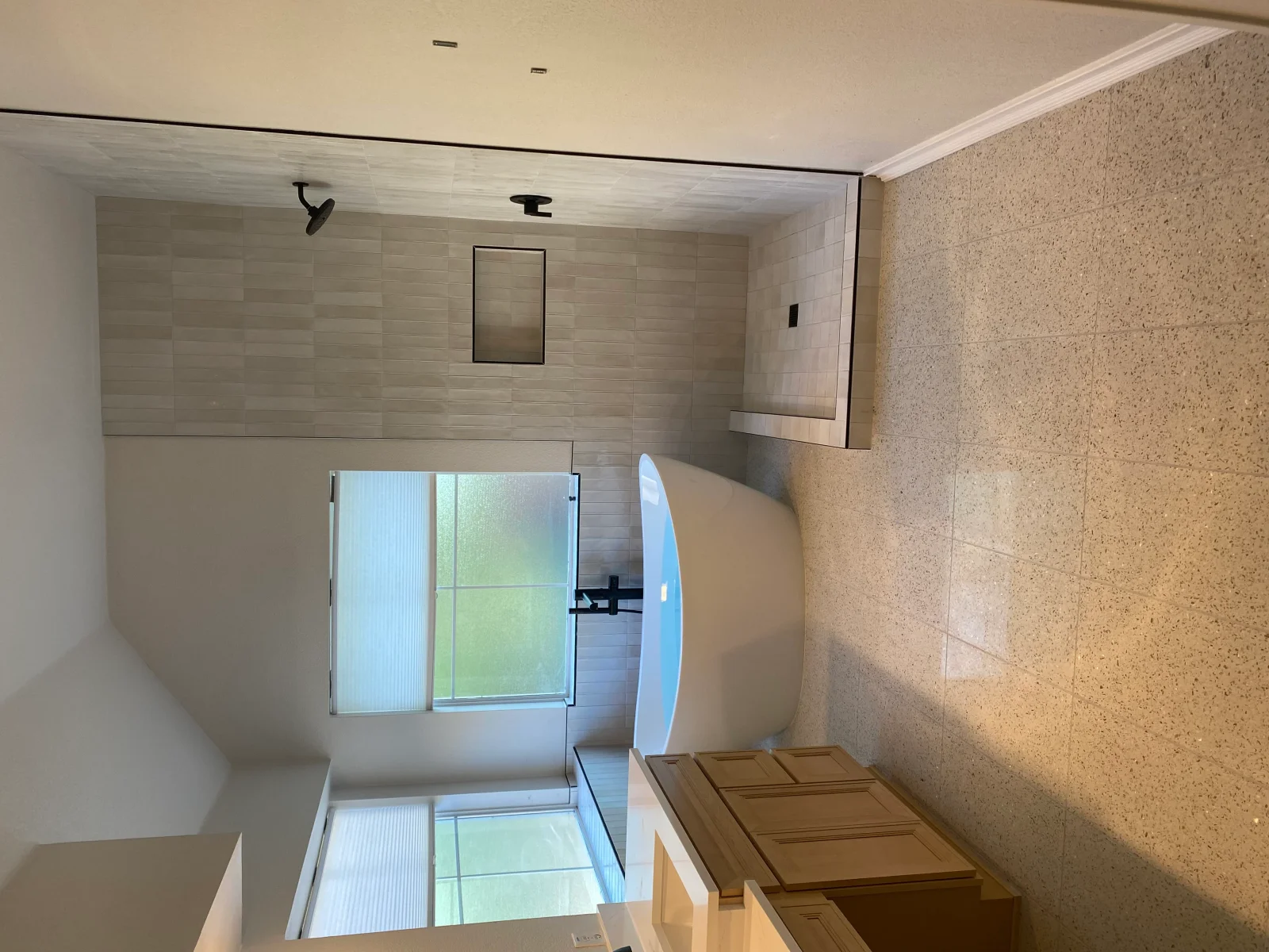 Bathroom shower with subway tile walls, glass enclosure, and textured accent tile